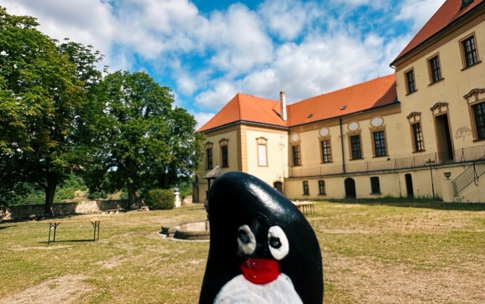 Hand-painted penguin stone #560 hidden at St. Nicholas' Deanery Church, Znojmo, Czechia (photo 1 of 5)