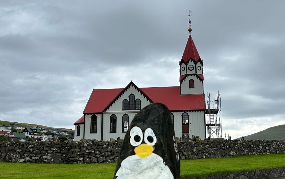 Hand-painted penguin stone #1066 hidden at Sandavags Kirkja, Sandavagur, Faroe Islands (photo 1 of 5)