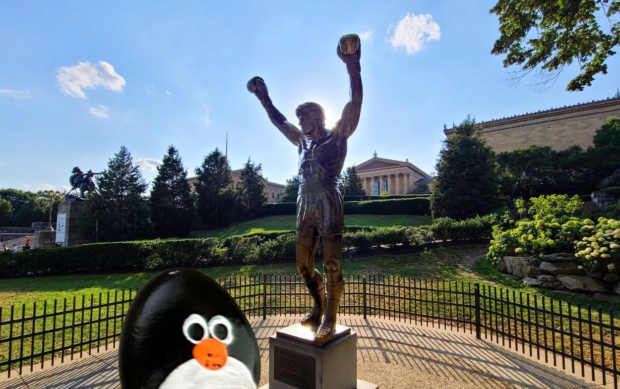 Hand-painted penguin stone #784 hidden at Stature of Rocky, Philadelphia, United States (photo 1 of 5)