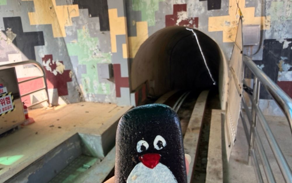 Hand-painted penguin stone #300 hidden at 3rd Tunnel, DMZ, South Korea (photo 1 of 5)