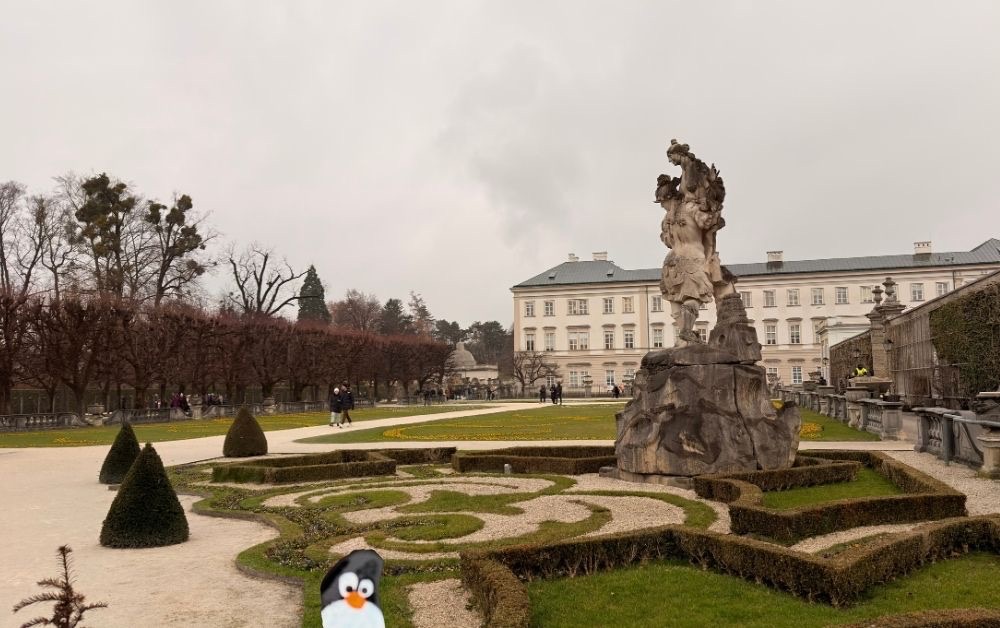 Hand-painted penguin stone #809 hidden at Mirabellgarten, Salzburg, Austria (photo 1 of 5)