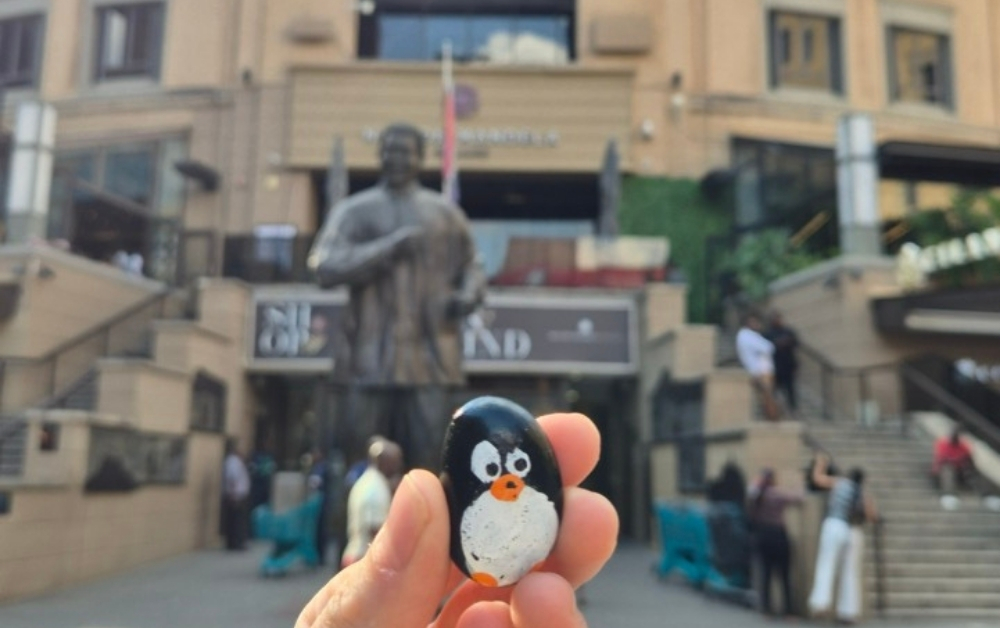 Hand-painted penguin stone #824 hidden at Nelson Mandela Square, Johannesburg, South Africa (photo 1 of 5)