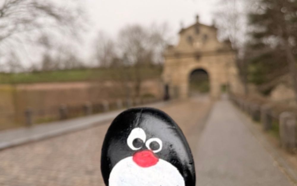 Hand-painted penguin stone #880 hidden at Leopold Gate in Vysehrad, Prague, Czechia (photo 1 of 5)