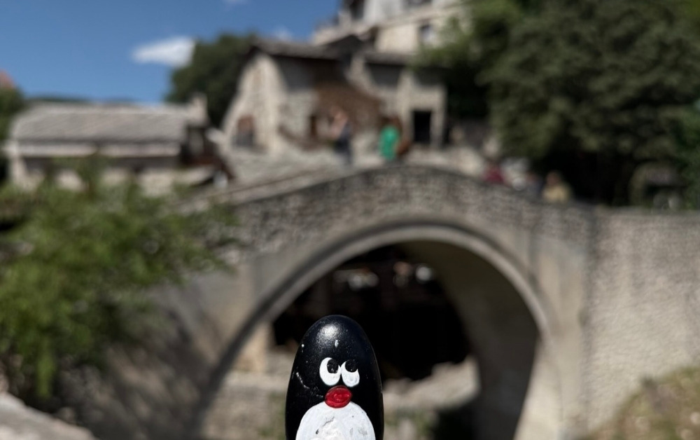 Hand-painted penguin stone #926 hidden at Crooked Bridge, Mostar, Bosnia and Herzegovina (photo 1 of 5)