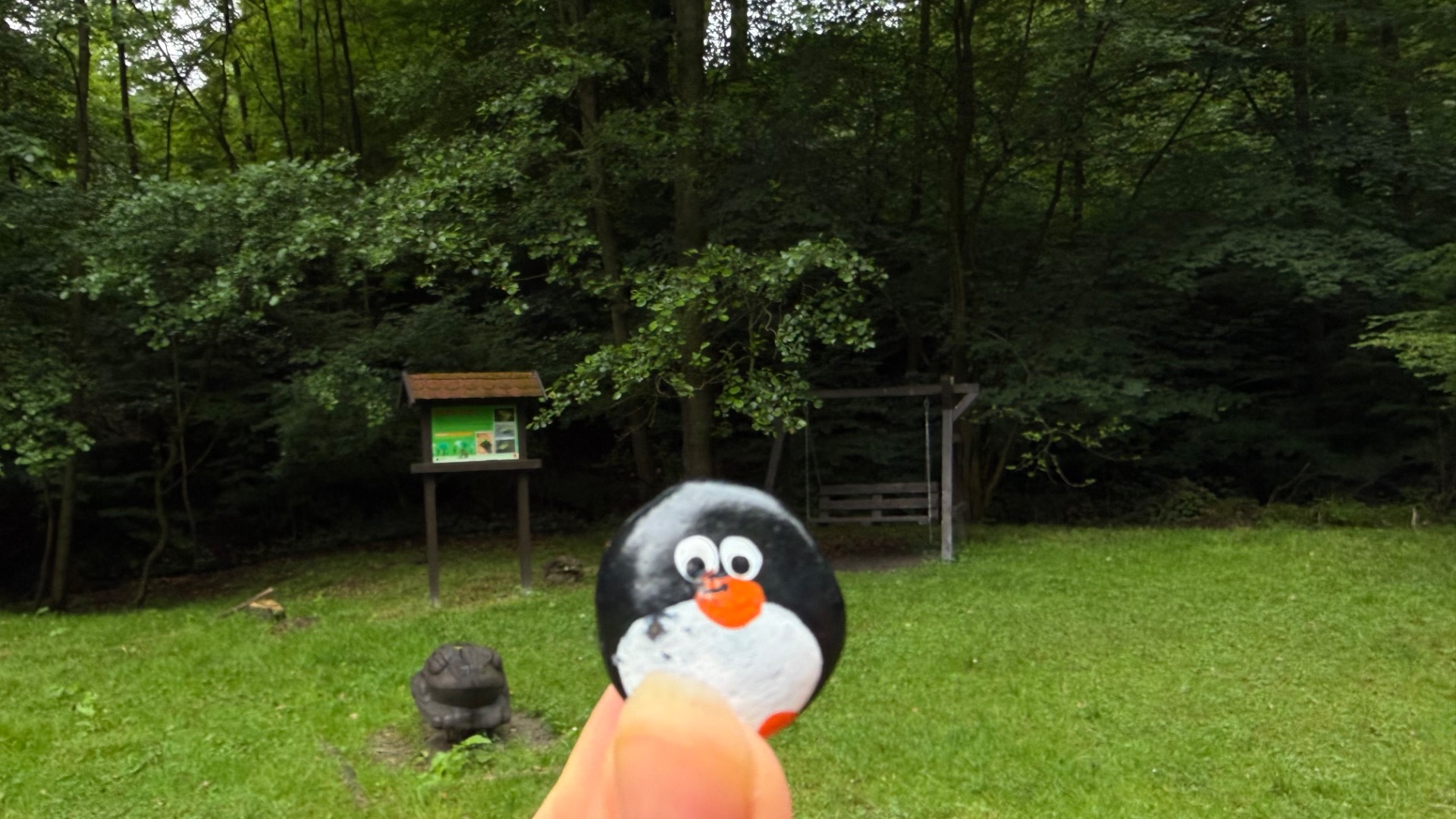 Hand-painted penguin stone #1129 hidden at Wooden Frog Statue, Bratislava, Slovakia (photo 1 of 4)
