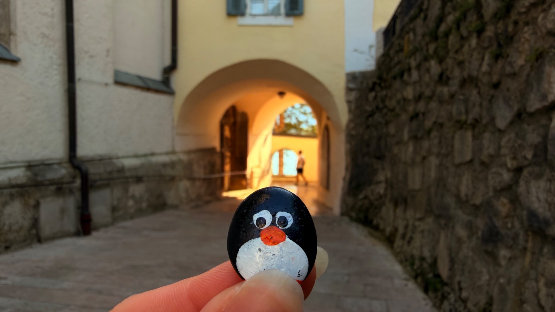 Hand-painted penguin stone #1162 hidden at St. Wolfgang Church, St. Wolfgang im Salzkammergut, Austria (photo 1 of 5)
