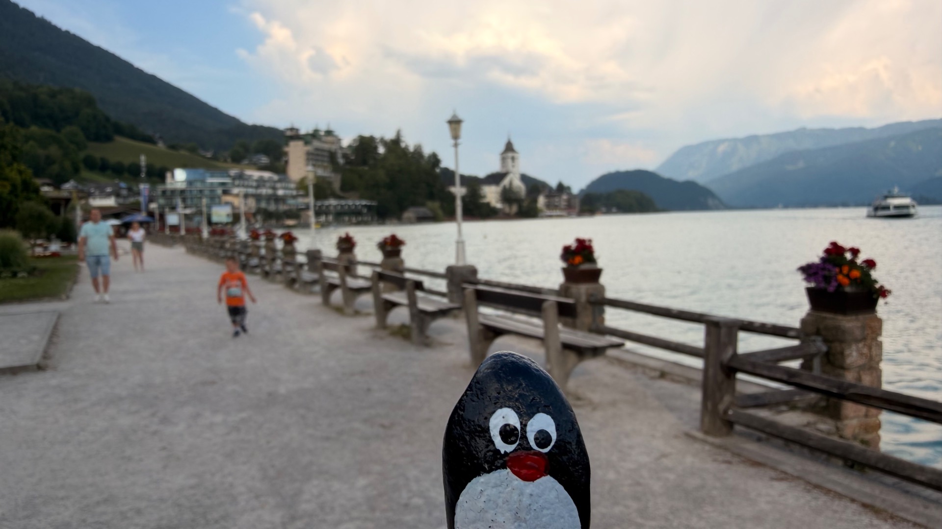 Hand-painted penguin stone #1234 hidden at Monument of Robert Stolz, St. Wolfgang im Salzkammergut, Austria (photo 1 of 5)