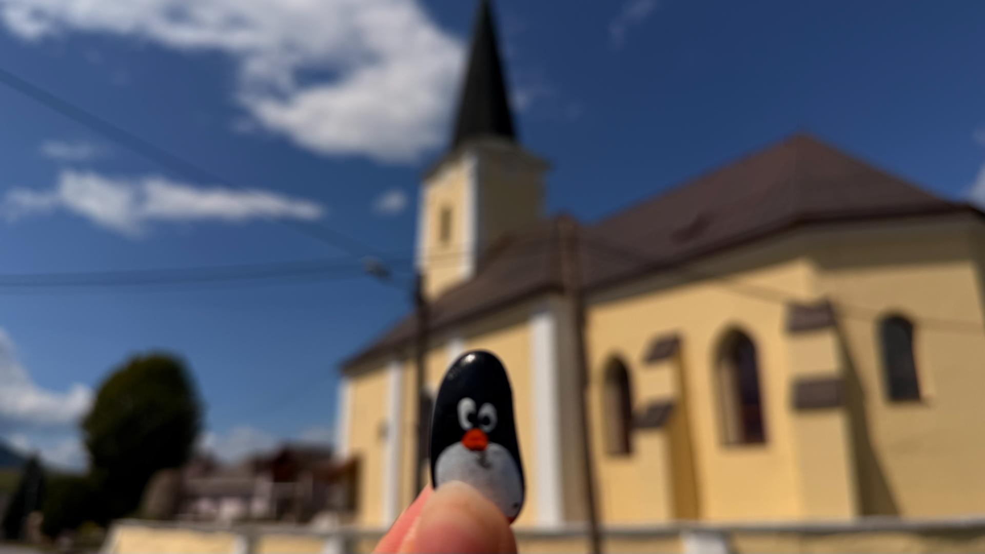 Hand-painted penguin stone #1106 hidden at Church of Saints Simon and Jude, Tulcik, Slovakia (photo 1 of 5)