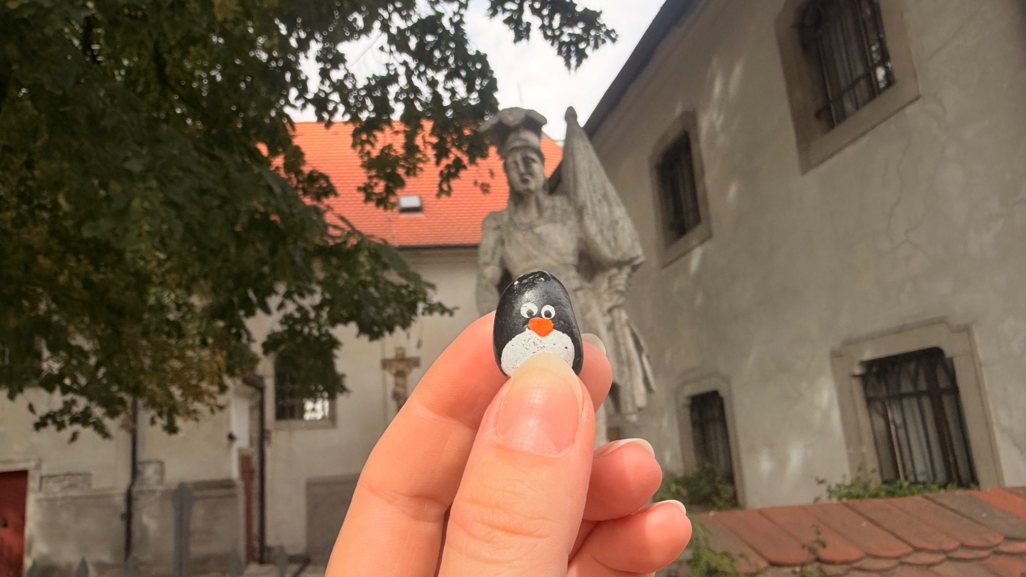 Hand-painted penguin stone #1085 hidden at The Holy Trinity Church, Bratislava, Slovakia (photo 1 of 5)