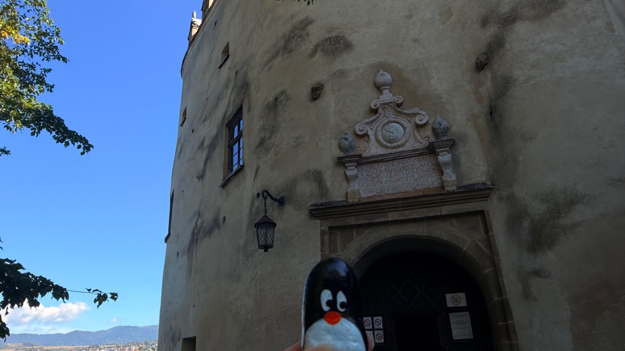 Hand-painted penguin stone #1353 hidden at Entrance Wall at Zamek Dunajec, Niedzica, Poland (photo 1 of 5)