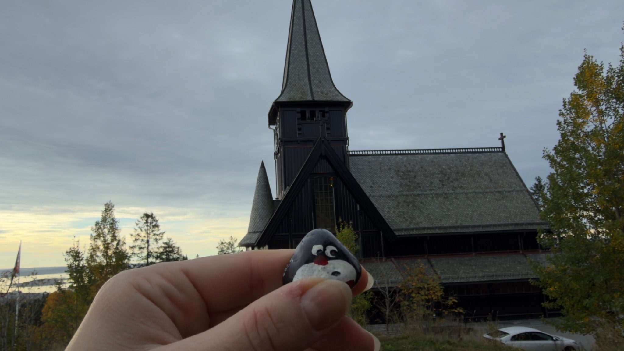 Hand-painted penguin stone #1238 hidden at Holmenkollen Chapel, Oslo, Norway (photo 1 of 5)