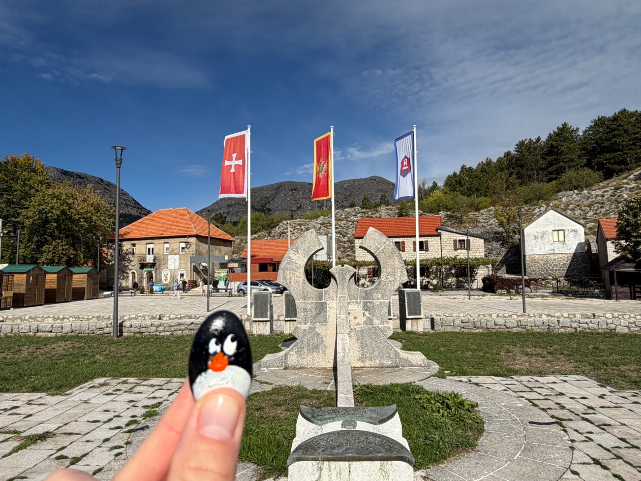 Hand-painted penguin stone #1517 hidden at Pomnik Ofiar Wojny 1941-1945, Njegusi, Montenegro (photo 1 of 4)