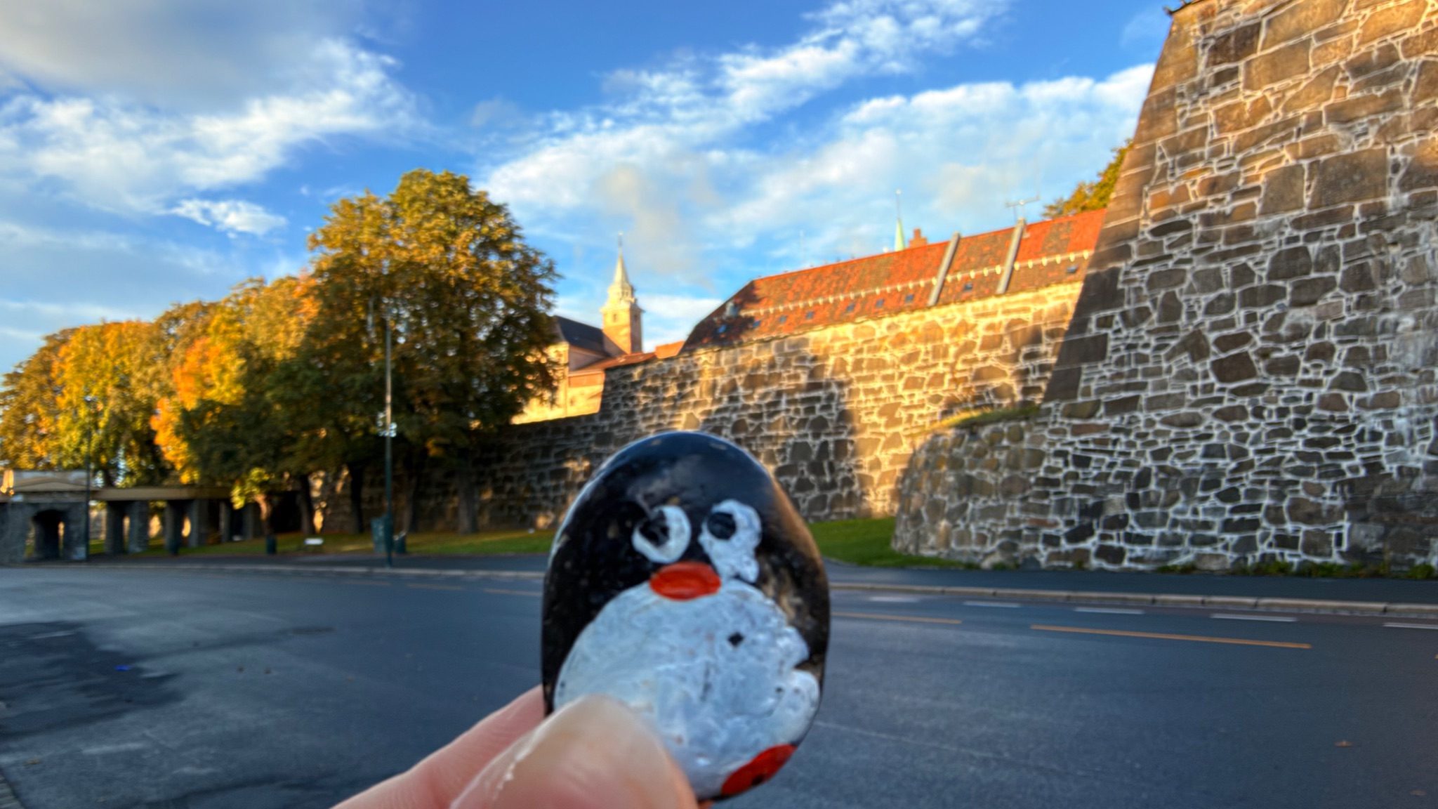 Hand-painted penguin stone #1524 hidden at Akershus Fortress Wall, Oslo, Norway (photo 1 of 5)