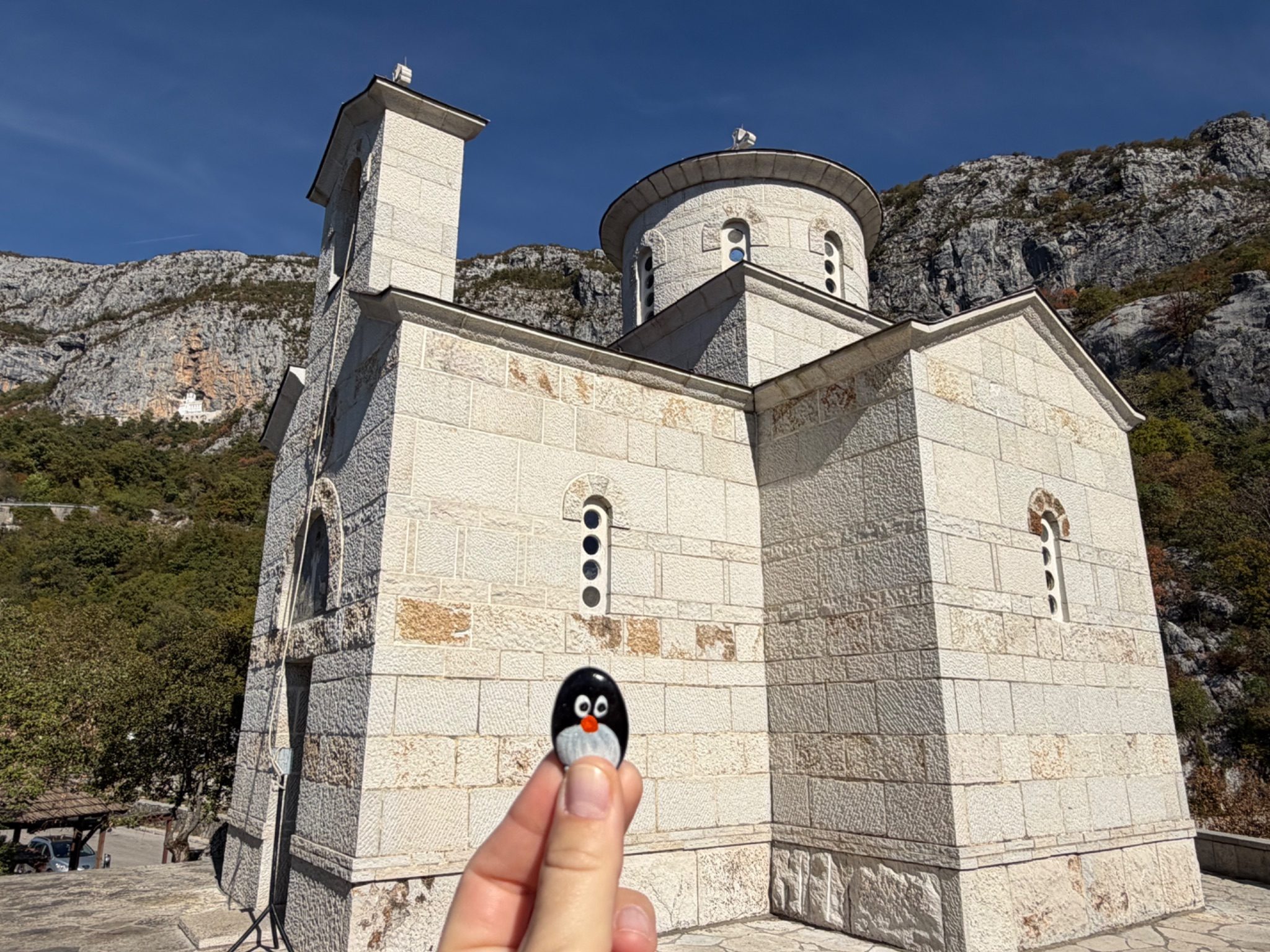 Hand-painted penguin stone #1537 hidden at The Church of the Holy Martyr Stanko, Ostrog, Montenegro (photo 1 of 4)