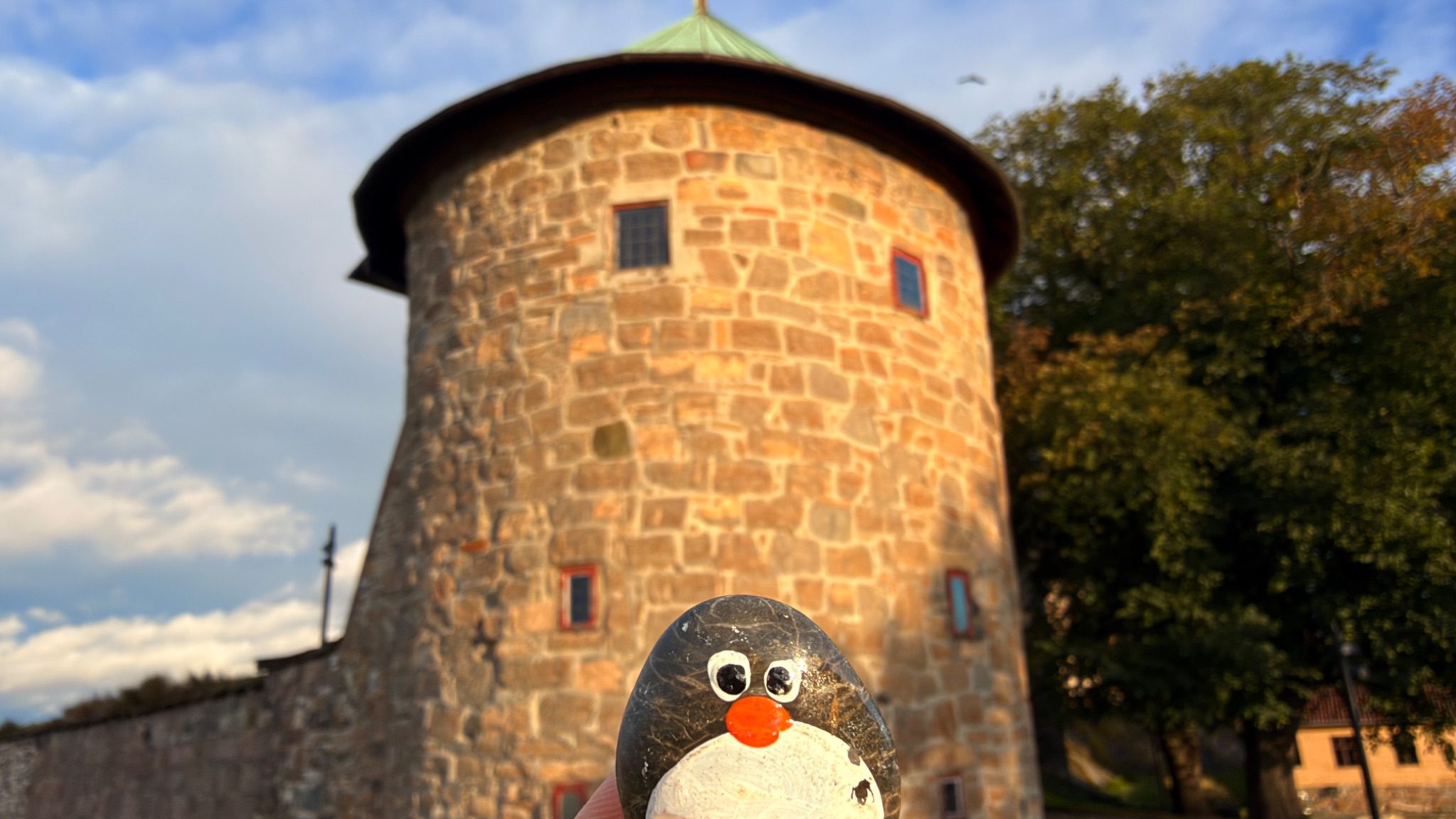 Hand-painted penguin stone #1894 hidden at Akershus Fortress Tower, Oslo, Norway (photo 1 of 5)